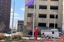 Kristie Hubbard, mother of organ donor Deveraux Hubbard II, raises a purple Gift of Hope flag outside the Carle Health Methodist Hospital campus in Peoria.