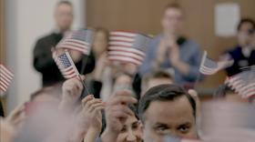 A group of people waving the American flag