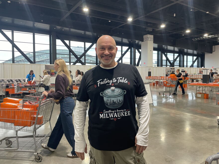 Dameon LaFayette wears a superfan t-shirt he and others created for the Le Creuset Factory-to-Table sale in Milwaukee. The shirt featured an AI-generated image of Milwaukee's "skyline."