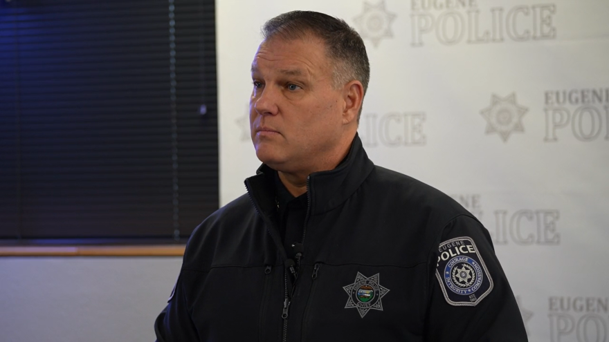 Eugene Police Chief Chris Skinner stands in front of a banner that reads "Eugene Police."