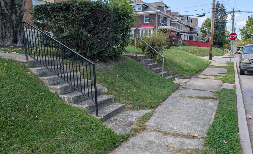 Concrete steps lead to front yards.