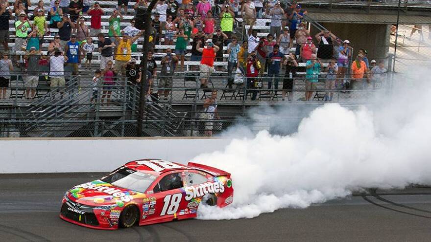 Kyle Busch celebrates his second consecutive Brickyard 400 victory with a burnout on the front stretch of the Indianapolis Motor Speedway.