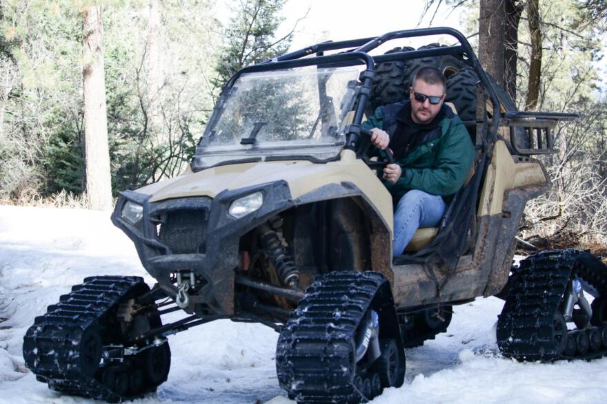 USDA's Travis Kolling backs up the UTV he drives to get to the snow pack measuring site.