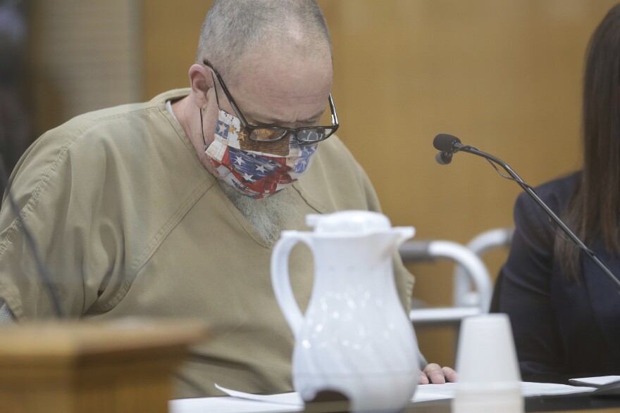 Brian Dripps reads his plea agreement at the Bonneville County Courthouse on Tuesday, Feb. 9, 2021 in Idaho Falls, Idaho. Dripps plead guilty to the rape and murder of Angie Dodge in 1996.