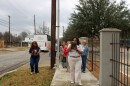 SAAACAM Docent Mackenzie Wilson guides guests off the bus toward the Carver Community Cultural Center.