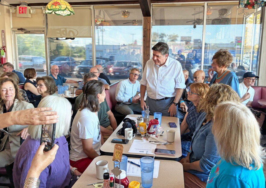 Gov. JB Pritzker speaks to Emily Waugh of Oregon at Lulu’s Diner in Springfield on Thursday, Aug. 27, 2026.