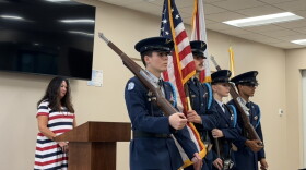Christine Dobkowski (left) viewing the Belleview JROTC present the colors at the Freedom Walk event in the Belleview Community Center.