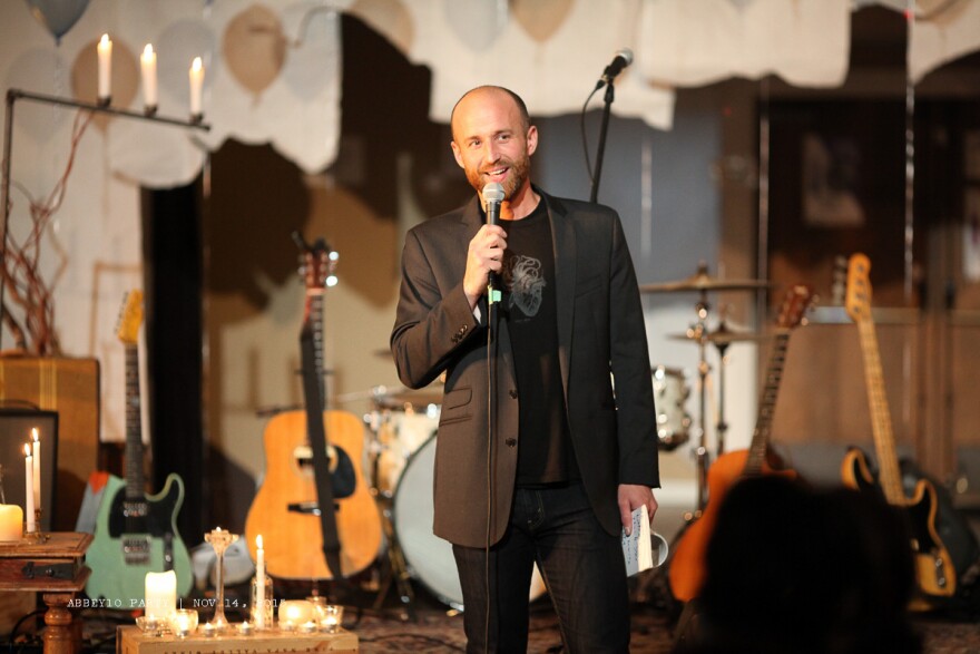 Nathan Marion stands on stage at the Fremont Abbey during a community concert.