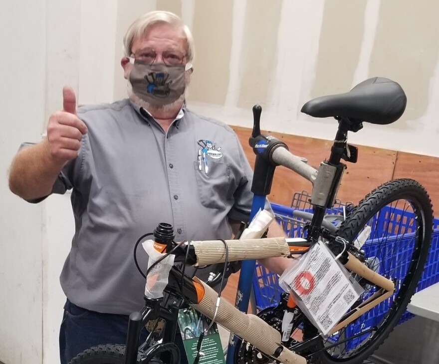 Man wearing mask with assembled bicycle