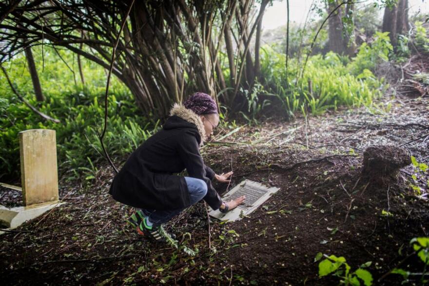 Annina Van Neel looks at a plaque commemorating the burial place of the remains of some   liberated African slaves found during the construction of a power plant, on October 18, 2017, at the graveyard of Saint Paul's Cathedral, south of Jamestown, in the British Overseas Territory of St. Helena. 
Skeletons of 325 former slaves were discovered during the construction of St. Helena's first airport on the South Atlantic island. After it abolished slave trade in 1807, Britain intercepted Portuguese slave ships sailing off the waters of St. Helena, which lies on what was then a notorious slave route from Africa to the Americas. Between 1840 and 1865, around 25,000 slaves were freed and released on St. Helena, according to historians. (Gianluigi Guerica/AFP via Getty Images)Skeletons of 325 former slaves were discovered during the construction of St. Helena's first airport on the South Atlantic island. After it abolished slave trade in 1807, Britain intercepted Portuguese slave ships sailing off the waters of St. Helena, which lies on what was then a notorious slave route from Africa to the Americas. Between 1840 and 1865, around 25,000 slaves were freed and released on St. Helena, according to historians. (Gianluigi Guerica/AFP via Getty Images)