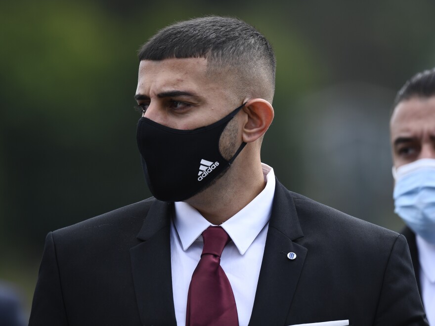 Nauman Hussain, who is charged with 20 counts of second degree manslaughter and criminally negligent homicide in a 2018 limousine crash, walks into a makeshift courtroom to accommodate more people at the Schoharie High School gymnasium Thursday, Sept. 2, 2021, in Schoharie, N.Y. (AP Photo/Hans Pennink)