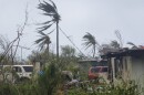 Debris covers the ground in Saipan on Wednesday, April 15, 2026, as a super typhoon with ferocious winds and relentless rains, shredded tin roofs and forced residents to take cover from flying tree limbs.