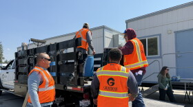 Hazmat crews from GrayMar from Mead, Wash., are cleaning up hazardous household materials after the Spokane Complex fires.