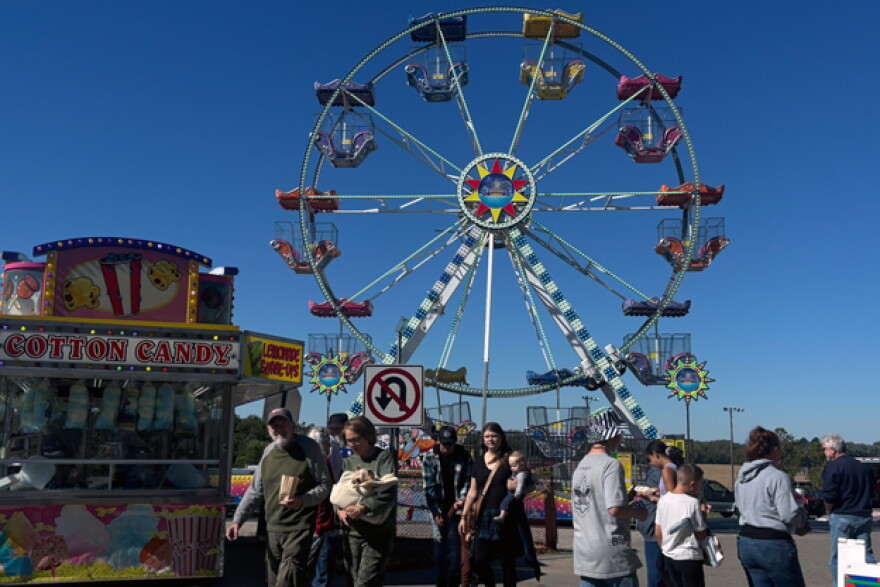 Visitors were able buy bands for tickets for rides such as the Ferris wheel. A cotton candy stand sits to the left of the Ferris wheel.