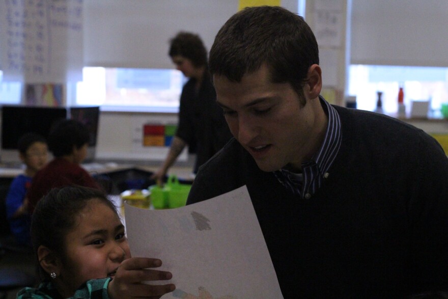 One of Paul Campbell's students shows him a drawing she made. (Photo by Wesley Early, Alaska Public Media - Anchorage)