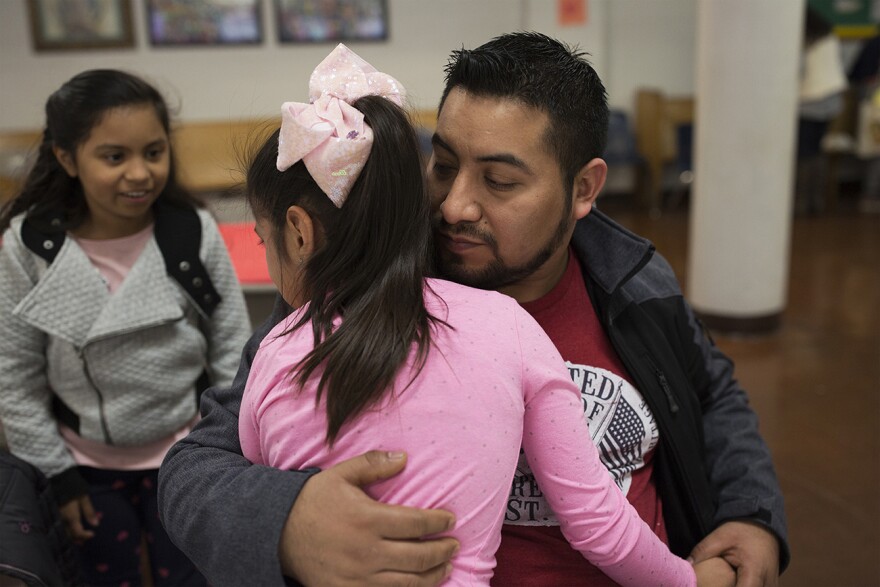 Garcia comforts Dana, 7, who has become sensitive since learning her dad is leaving. Nov. 19, 2017