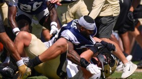 Dallas Cowboys outside linebacker Sam Williams, top, fight with New Orleans Saints tight end Moliki Matavao during an NFL football joint practice, Tuesday, Aug. 18, 2026, in Oxnard, Calif.