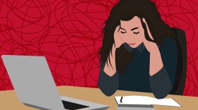 An illustration of a stressed woman sitting at a desk with her head in her hands with a laptop open beside her.