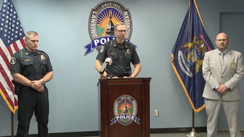 Lansing Police Chief Rob Backus in the middle talking. 