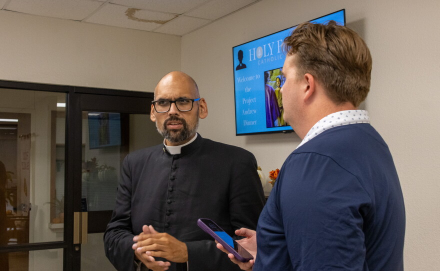 KACU reporter Caysson Higgins interviewing Father Ryan who is the vocational director at Holy Family Catholic Church, photo by Alexander Brown.