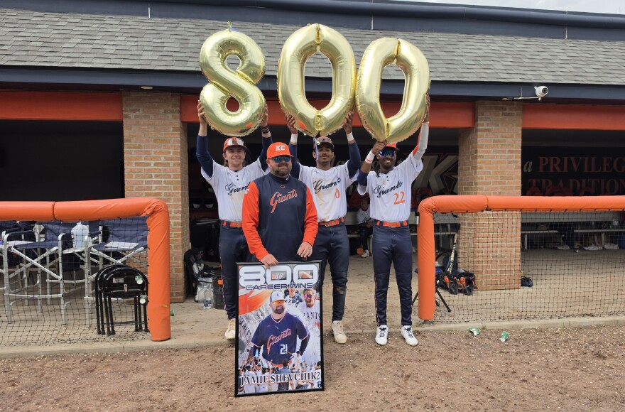Keystone College baseball Coach Jamie Shevchik poses with three of his players after the Giants won 10-8 on Friday afternoon, earning the coach his 800th victory.