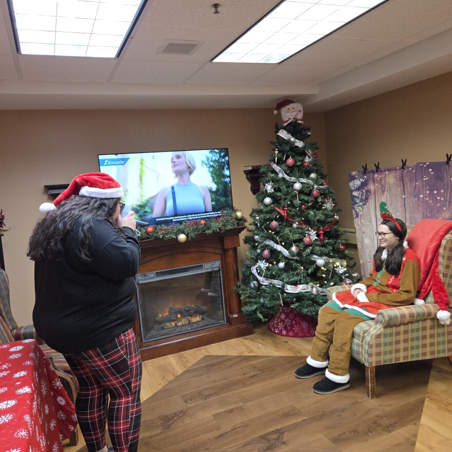 Havenwood Activity Director Kim Sundquist, left, and activity aide Elizabeth Karratti test out the Polaroid photo booth in Bemidji on Dec. 11, 2025.