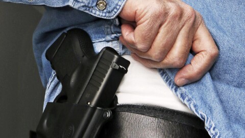 FILE - In this Feb. 27, 2013 file photo Hank Johnson displays his handgun, in Springboro, Ohio. Dealing a blow to gun supporters, a federal appeals court ruled Thursday, June 9, 2016, that Americans do not have a constitutional right to carry concealed weapons in public.