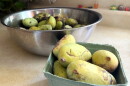 Two bowls of green pawpaws sit on a kitchen counter.