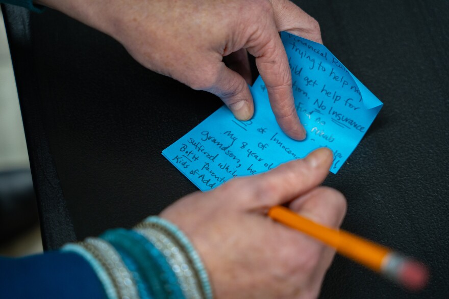 A person with lived experience of addiction writes down their thoughts on how opioid settlement funds should be spent in Mississippi during a listening session hosted by the Gulf States Newsroom at James Moore’s bike shop in Hattiesburg, Mississippi, on January 28, 2026.
