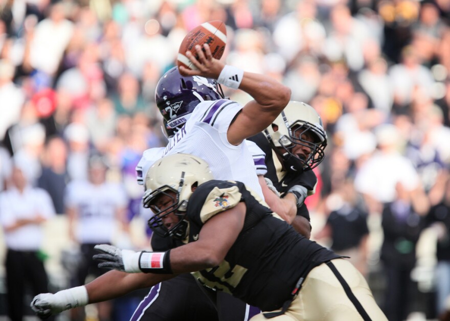 Northwestern's Kain Colter is tackled during a game with Army in 2011. Colter has argued the players should be allowed to form a union.