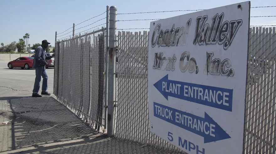 FILE PHOTO: A security guard opens the gate at the Central Valley Meat Co., the California slaughterhouse recently shut down by federal regulators after they received a graphic video of cows being mistreated.