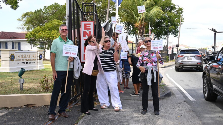 Pictured: Water Island residents and supporters gather outside the Earle B. Ottley Legislative Hall on St. Thomas on Tuesday, urging senators to reject a proposed 99-year lease for a $400 million resort development. Despite opposition, lawmakers approved the amended lease in an 11-3 vote.