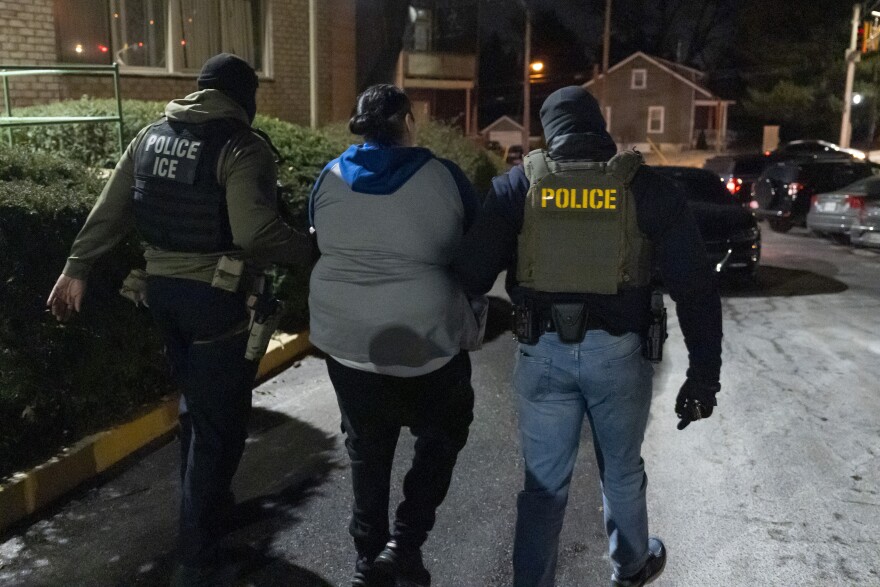 U.S. Immigration and Customs Enforcement officers detain a person, Monday, Jan. 27, 2025, in Silver Spring, Md. (AP Photo/Alex Brandon)