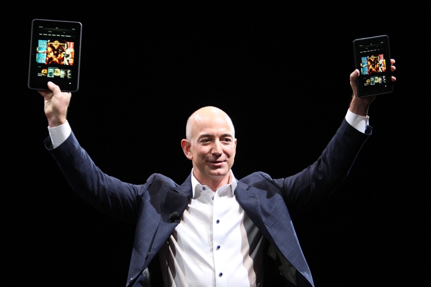 Amazon CEO Jeff Bezos holds up the Kindle Fire HD in two sizes during a press conference in Santa Monica, Calif., in September 2012.