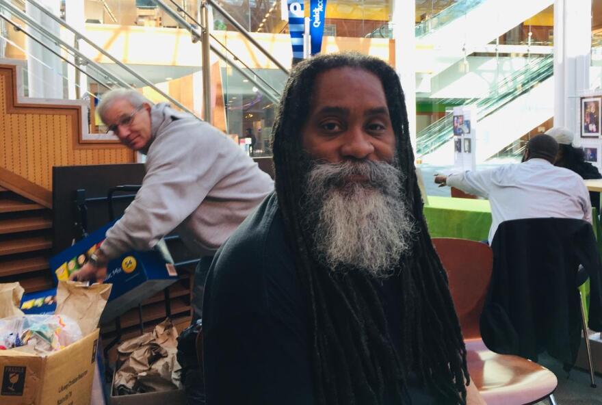 Maurice Young hands out lunches at an Indianapolis library. He also helps people navigate health insurance. (Jill Sheridan/IPB News)