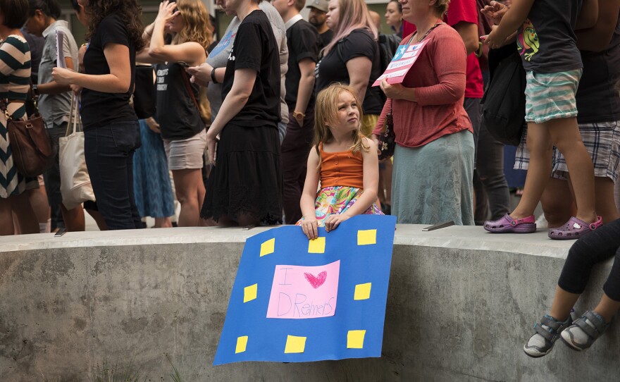 Sylvia Foster, 7, holds a sign that reads 'I <3 Dreamers' during a community rally in support of DACA recipients on Tuesday, September 5, 2017, at El Centro De La Raza in Seattle. 