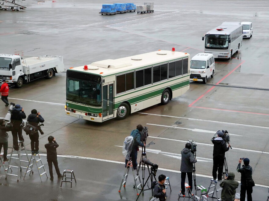 A bus (front) believed to be carrying former US special forces member Michael Taylor and his son Peter who allegedly staged the operation to help fly former Nissan chief Carlos Ghosn out of Japan in 2019, leaves Narita airport in Chiba prefecture on March 2, 2021 following their extradition from the US. (Photo by STR / JIJI PRESS / AFP) / Japan OUT (Photo by STR/JIJI PRESS/AFP via Getty Images)