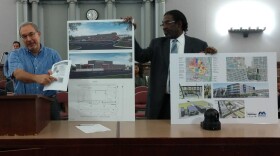 Bill Laskowsky (left) and Darryl Piggee, representatives of the Northside Regeneration urgent care project, show renderings for the proposal.