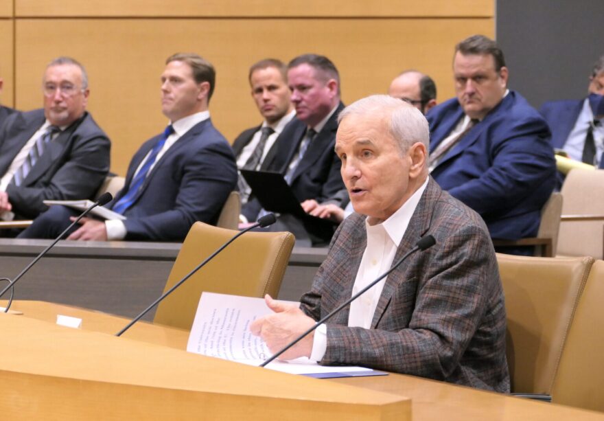 Former Minn. Gov. Mark Dayton speaks into microphone