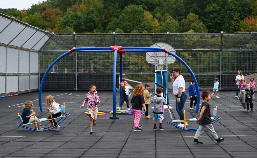 Kindergarten students at Saint Clair play on the rooftop playground during recess.
