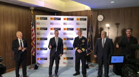 Various federal and Kodak officials gather for a photo-op after the signing of the deal that will provide the company with a $765 million loan.