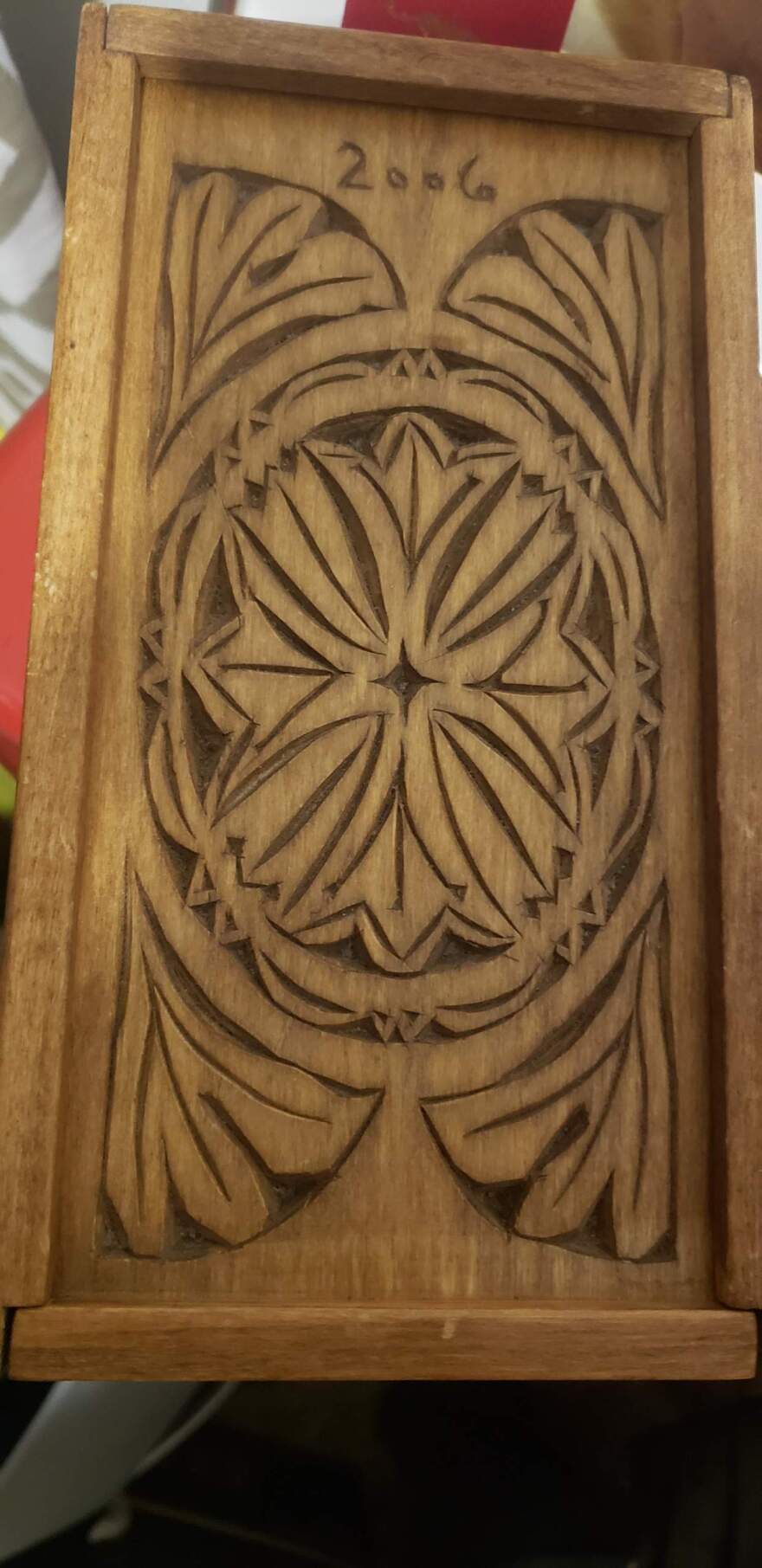 An intricate carving in a flat piece of wood