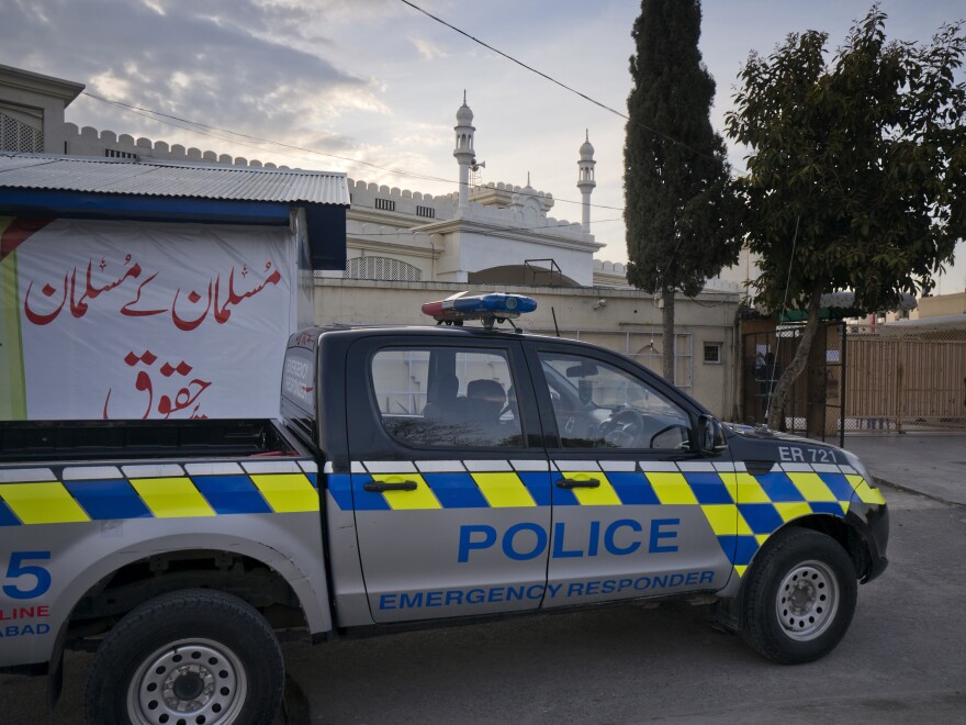 A police vehicle is parked outside a mosque belonging to a banned religious group in Islamabad, Pakistan. Prime Minister Imran Khan has ordered the takeover of assets and property of dozens of militant organizations who continue operating in Pakistan.