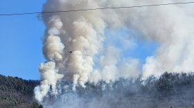 A helicopter dumping water on the fire on East Mountain Tuesday 