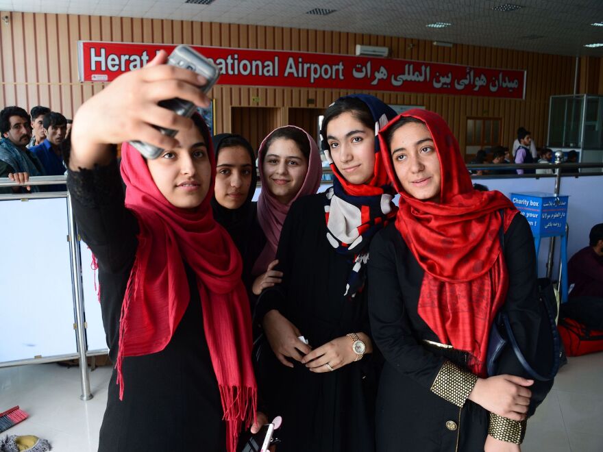 After twice being denied visas, a team of Afghan girls, who stopped for a photo at Herat International Airport in western Afghanistan on Thursday, has been permitted to travel to the U.S. for a robotics competition.