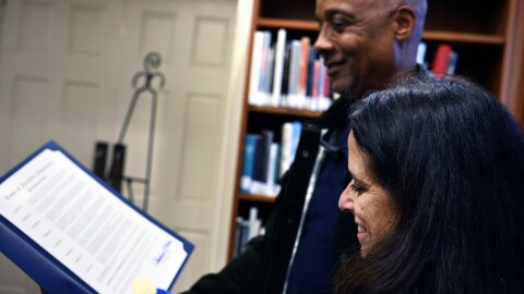 Fairfield First Selectman Christine Vitale reads from the town proclamation calling on town residents to pay tribute to Dr. Martin Luther King Jr. Day by volunteering with local nonprofits and advocacy groups in the area. Standing next to her is Steve Bogan, a former member of the town's now defunct Racial Equity and Justice Task Force, at the Fairfield Public Library on January 14, 2025