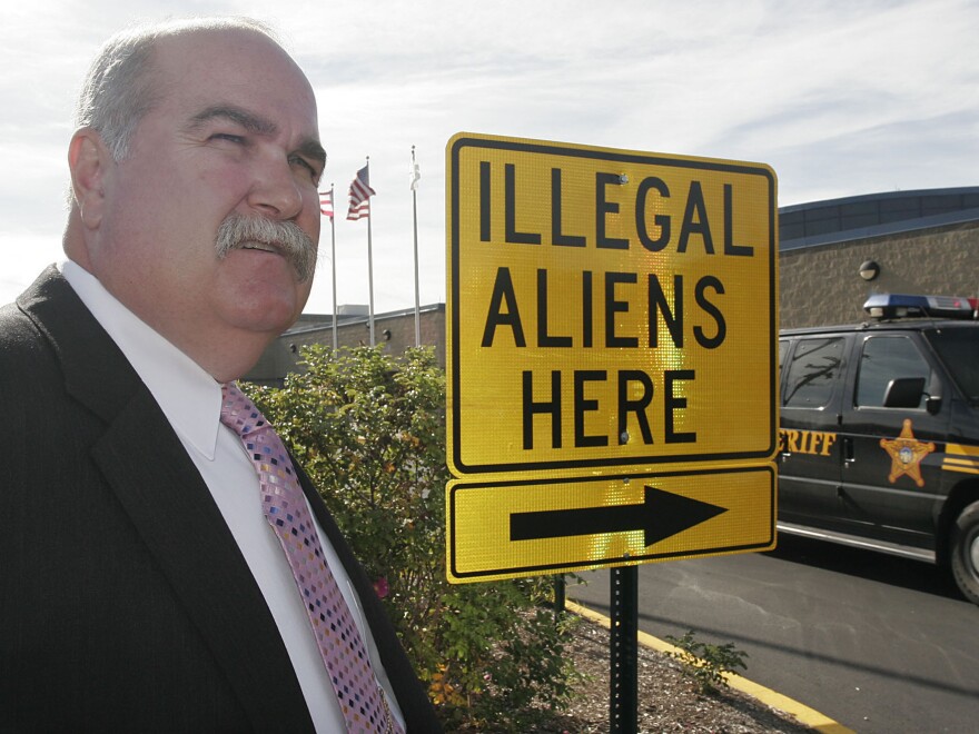 Butler County Sheriff Richard Jones stands next to a illegal aliens sign he had placed in the parking lot of the Butler County Sheriff's Department, Nov. 3, 2005, in Hamilton, Ohio.