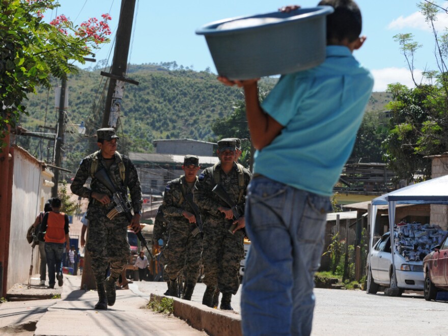 Honduran soldiers patrol poor neighborhoods in the outskirts of Tegucigalpa due to a deterioration of the police force.