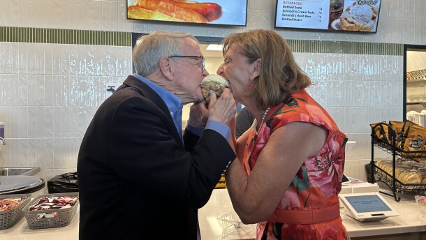 Gov. Mike and First Lady Fran DeWine share a Schmidt's Cream Puff in front of reporters at the Ohio State Fair in 2026.
