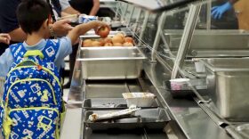 A student picks out an apple in the school cafeteria at Thelma R. Parks Elementary in Oklahoma City.